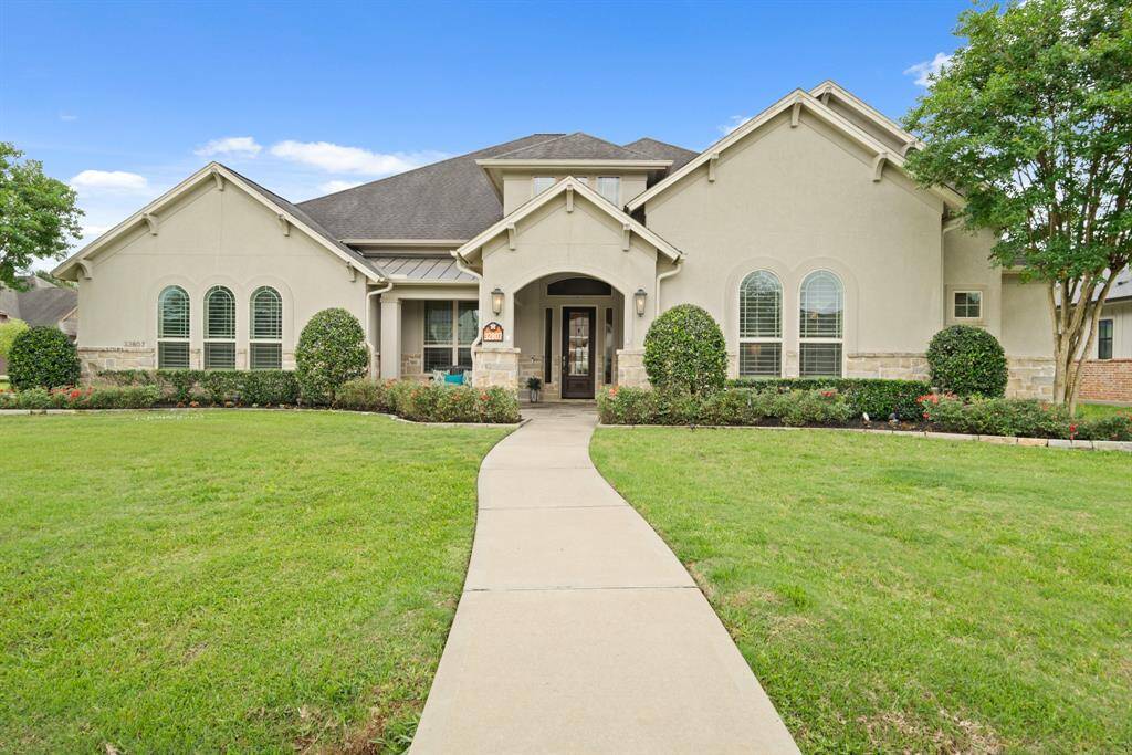 This picture-perfect, single-story home boasts a stucco and stone exterior with lush and manicured landscaping. The gable roofing is accentuated with impressive corbels that draw the eyes upward and enhance the home’s excellent curb appeal.