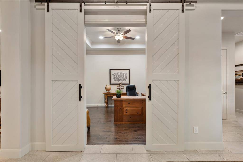 Stylish barn doors provide access to the home Study located directly off the Foyer. When peace and quiet is needed for added concentration, these doors fully close to provide a tranquil space where creativity can flow.