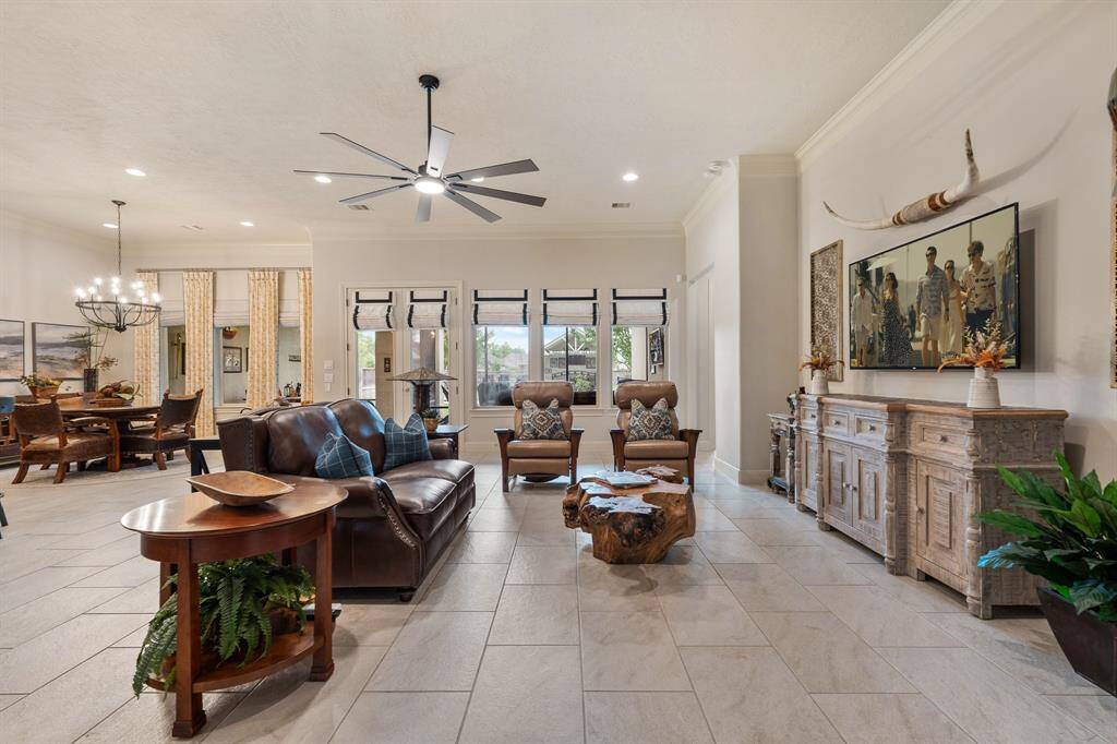 “Comfortable” is an apt description for this Family Room that offers simple sophistication and a casual laid-back style that puts everyone at ease. Large windows flood the room with both natural light and never-ending views of the Backyard Oasis beyond.
