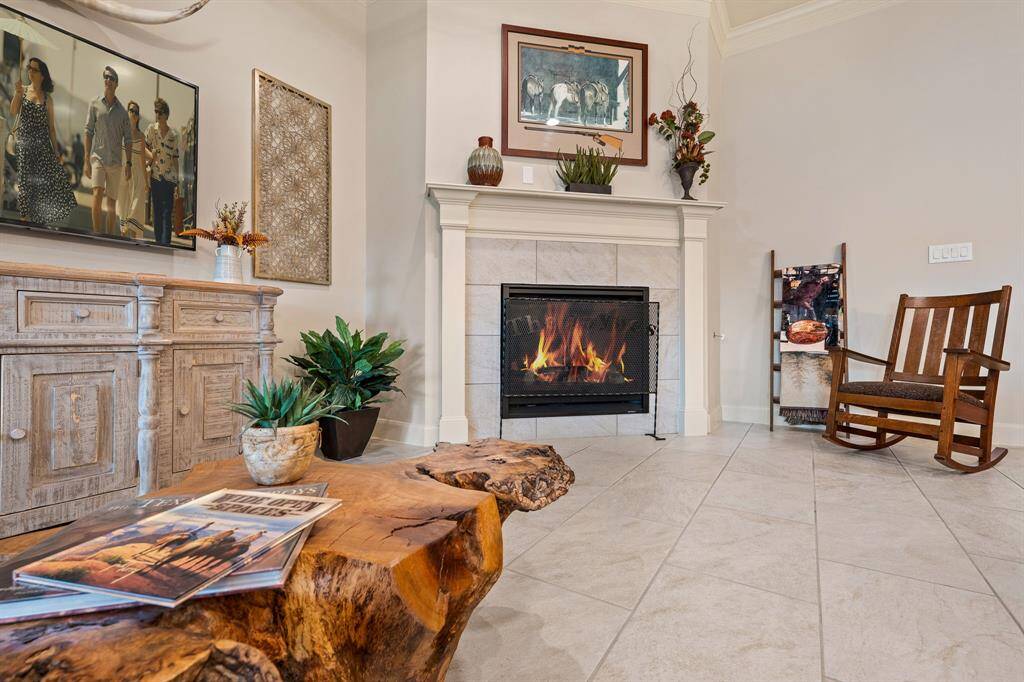 The heart of the space is this gas-log fireplace, inlaid in tile and surrounded by a custom-made mantle.