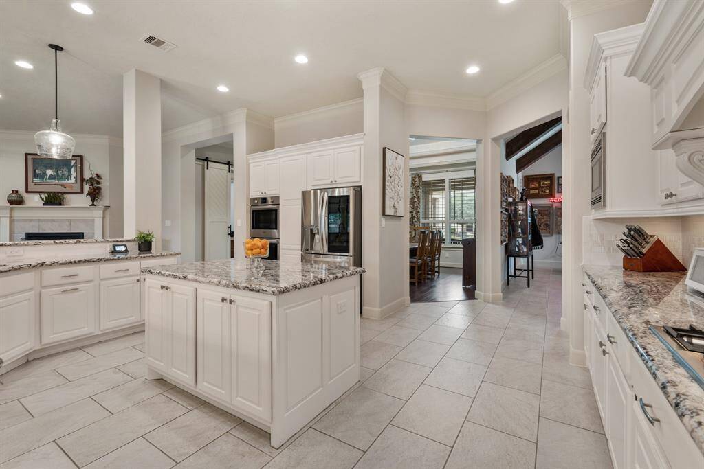This view offers a look at how the room flows into the Dining Room and Game Room ahead, making it easy to swing back for second helpings. An oversized walk-in Pantry provides an abundance of organized space to store both food and small appliances.