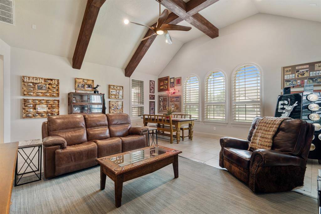 This Game Room is located directly off the Kitchen and provides a casual space for entertaining groups both big and small. The wood beamed cathedral ceiling immediately captures the attention and draws the eyes upward. The arched windows are fully cased and adorned with plantation shutters, allowing full control of the amount of natural light that spills into the space.