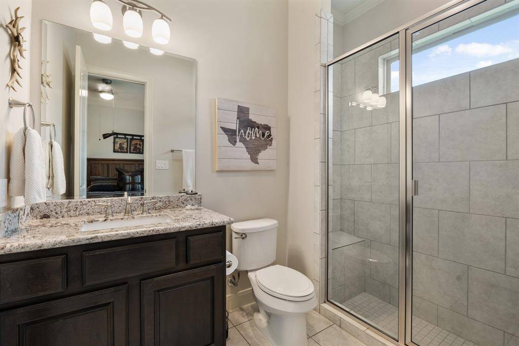 This ensuite Bathroom comes equipped with granite countertops, an undermount sink, and walk-in shower with bench seat.
