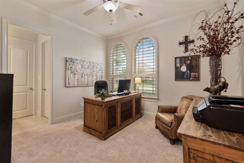 Two more Secondary Bedrooms can be found toward the front of the home and are adorned with plush carpeting, arched windows, plantation shutters, crown molding, walk-in closets, and direct access to a Jack and Jill Bathroom.