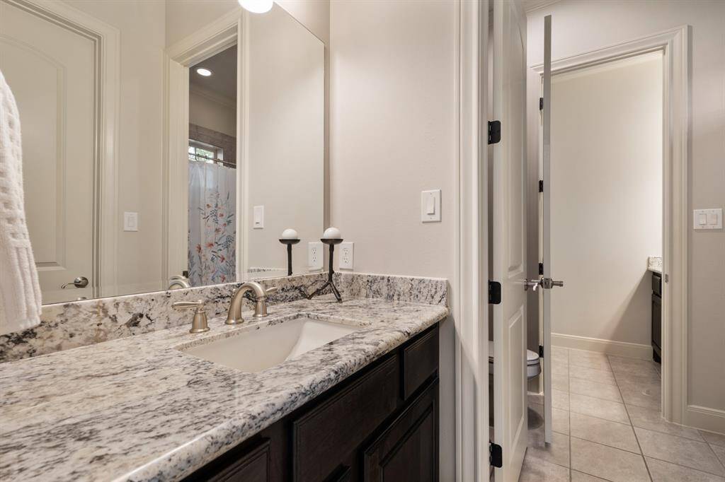 The third and fourth Bedrooms each have their own granite-topped vanity with an undermount sink, allowing two people to get dressed and ready for the day at the same time. Doors separate a shared shower/tub combo of this Jack/Jill Bath.