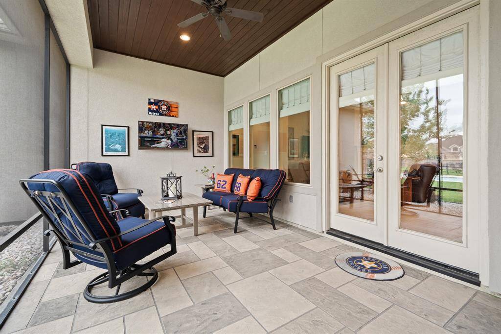Glass-plated double doors provide direct access to this wrap-around, Screened-In Patio from the Family Room. Mirroring the home’s Front Porch, this space boasts low maintenance slate tile flooring and decorative beadboard ceiling.