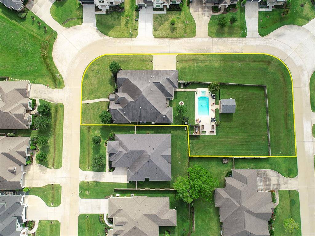 It takes a bird’s eye view to truly get an idea of how special this double corner lot is! This home is built inside and out for entertaining!