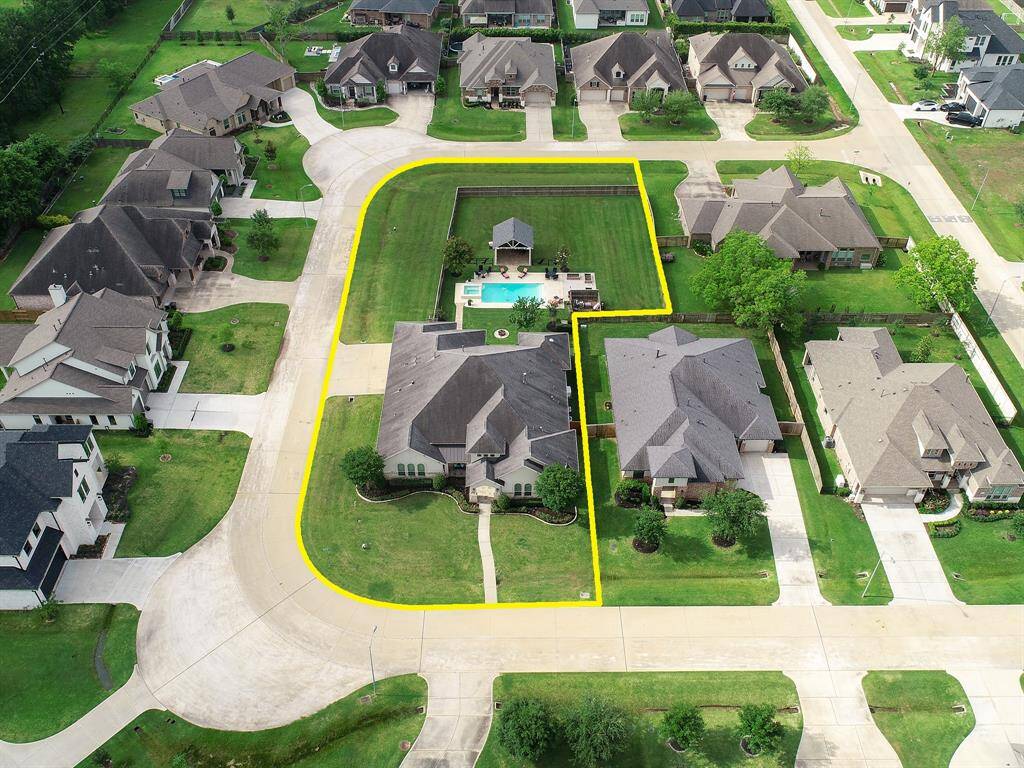 This highly desirable corner lot is best appreciated from this bird’s eye view. Notice how the Pool and entertainment space of the Back Yard is so large and grand, and yet only takes up a small space of what this yard has to offer. There is still room to grow, to dream, and to explore.