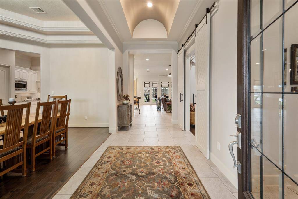 This home leaves a lasting first impression immediately upon entering! The Foyer boasts a cased opening, crown molding, and a dramatically beautiful, barreled ceiling. The eyes are immediately drawn down this extended Foyer and through the windows overlooking the spectacular Backyard.