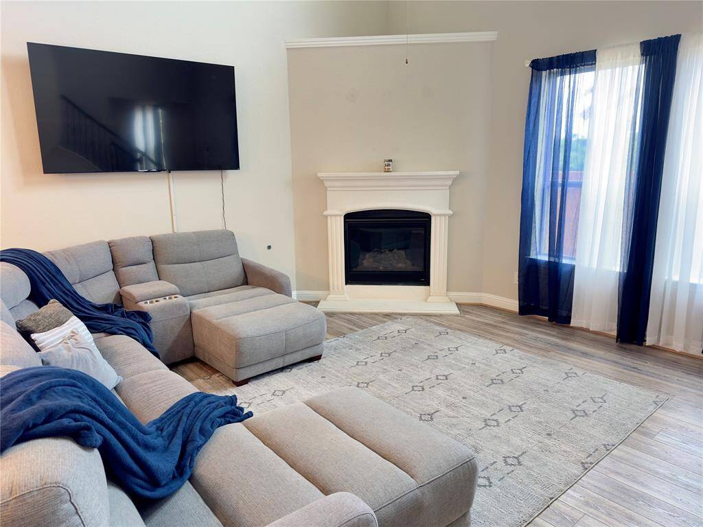 Cozy family room featuring a charming gas log fireplace.