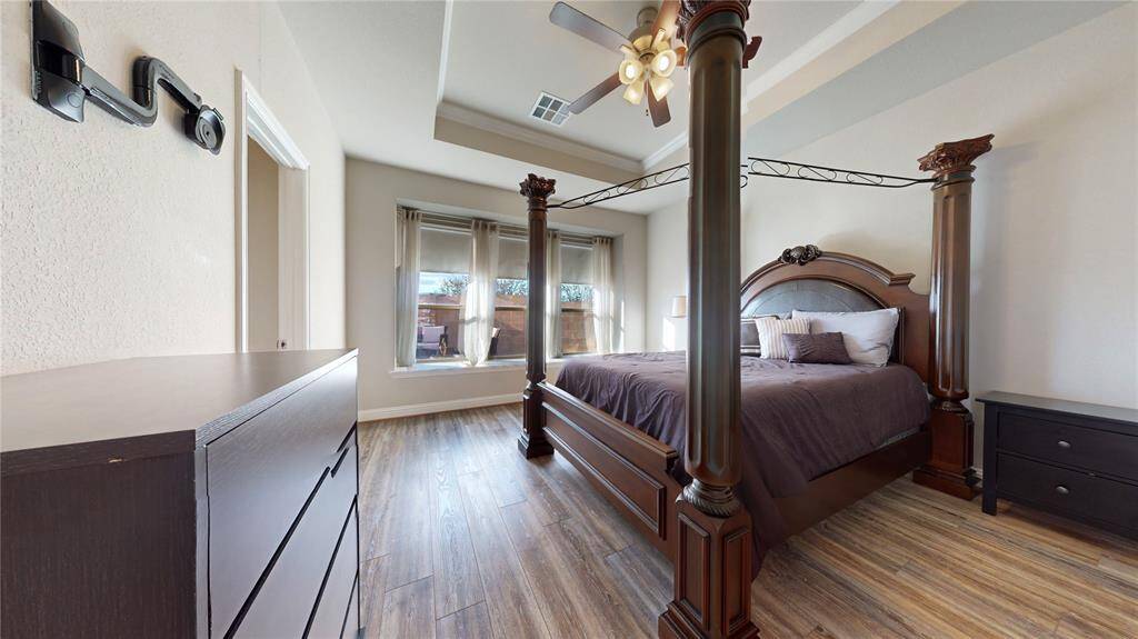 Step into the elegant primary bedroom featuring a sophisticated tray ceiling.