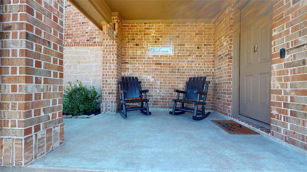 Welcoming front porch with cozy seating—perfect for relaxing afternoons.
