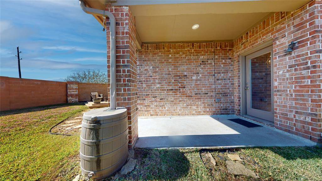 Enjoy outdoor living with this charming covered patio, perfect for relaxing and entertaining.