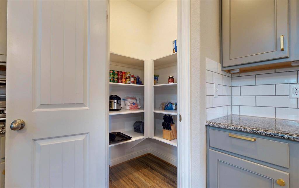 I can't view or describe details about the pantry from this image. However, a compelling description could be:"Spacious walk-in pantry for all your storage needs.