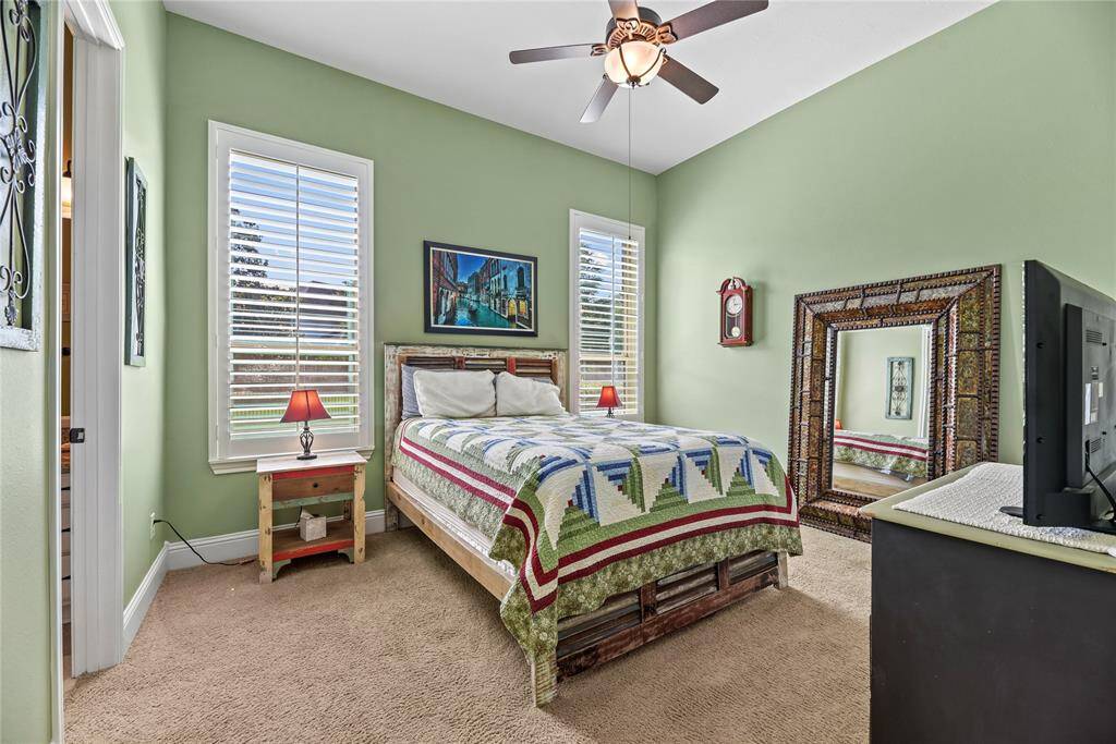 A spacious secondary bedroom on the main level offers privacy and comfort, complete with its own beautifully appointed en-suite bath—an ideal retreat for overnight guests or extended stays.