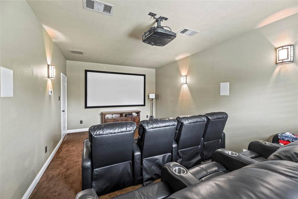 The media room is a cutting-edge entertainment retreat, featuring immersive surround sound and a high-definition projector, delivering a truly cinematic experience that transforms every movie night or gaming session into an unparalleled luxury event.