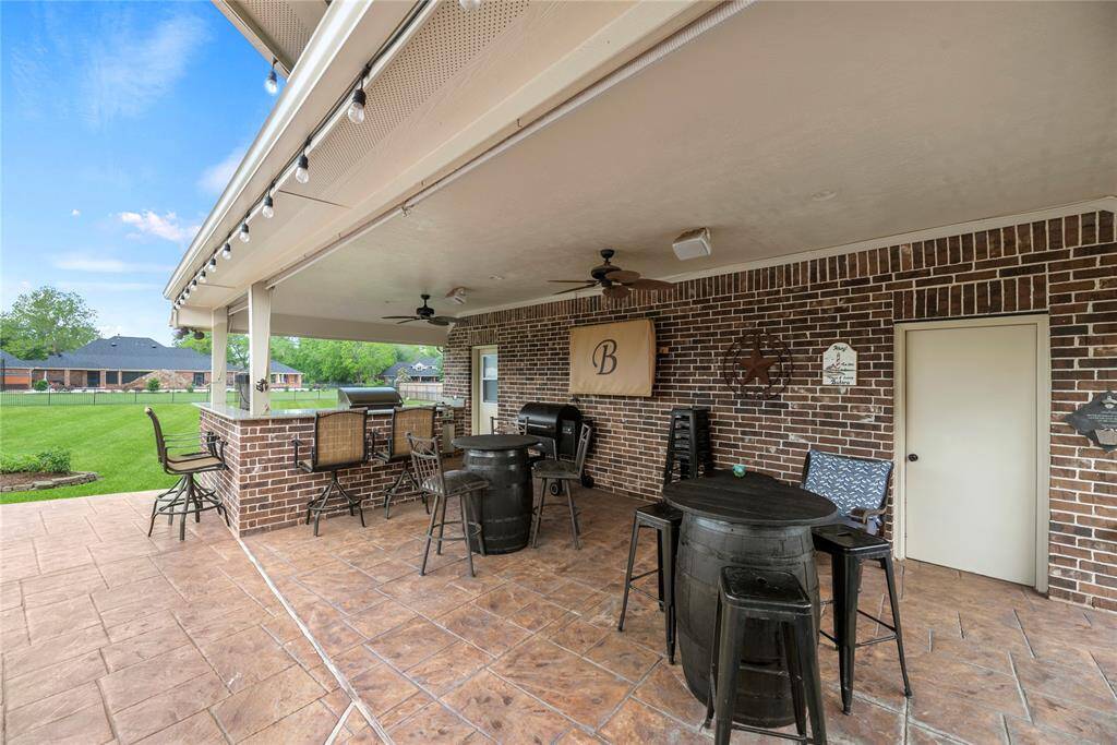 The expansive patio, complete with a fully equipped outdoor kitchen, creates a great space for alfresco dining and entertaining, perfect for hosting guests or enjoying serene outdoor moments.