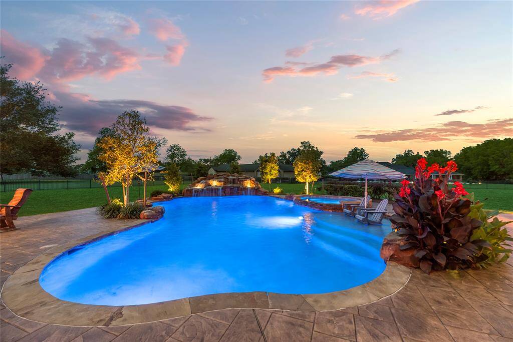 Immerse yourself in the glow of this beautifully illuminated pool and indulge in a resort-style escape—without ever leaving the comfort of your own backyard.