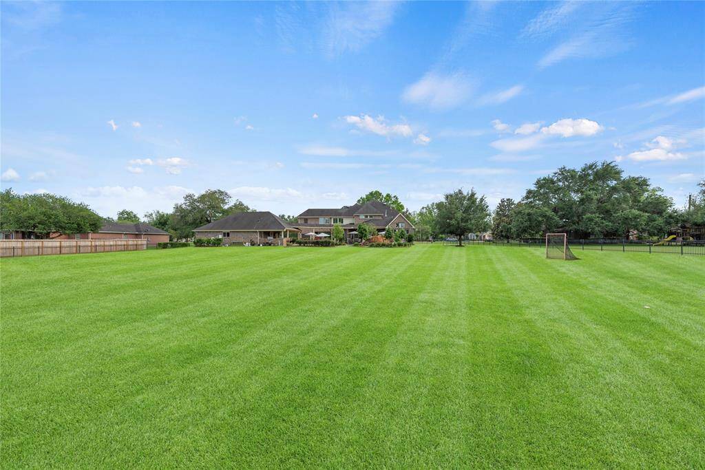 This sprawling green space is the ultimate outdoor playground, perfect for family games, backyard adventures, or simply soaking up the sun—combining beauty, freedom, and endless fun in a vibrant, park-like setting.