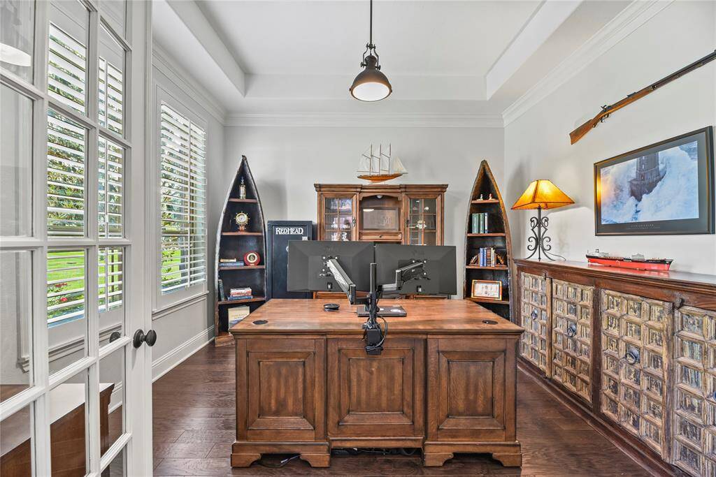 To the left of the entry, the sophisticated study features double glass doors, elegant shuttered windows, and an abundance of natural light—offering a serene and stylish space for work or reflection.