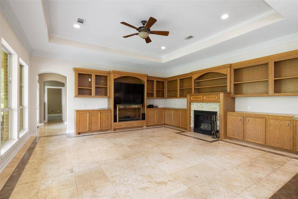 This family room has much to offer with the built-in cabinets for your pictures and art pieces, and the cozy fireplace.