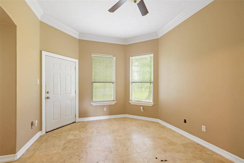 Another secondary bedroom complete with crown molding, tile floors and great closet space.