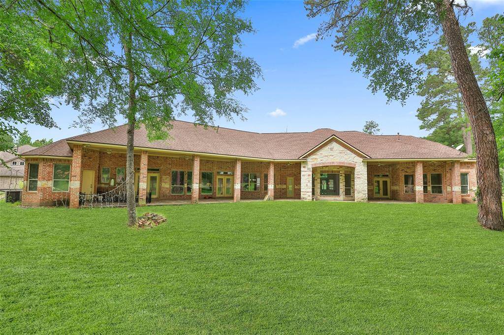The back yard view of this sprawling one story house.