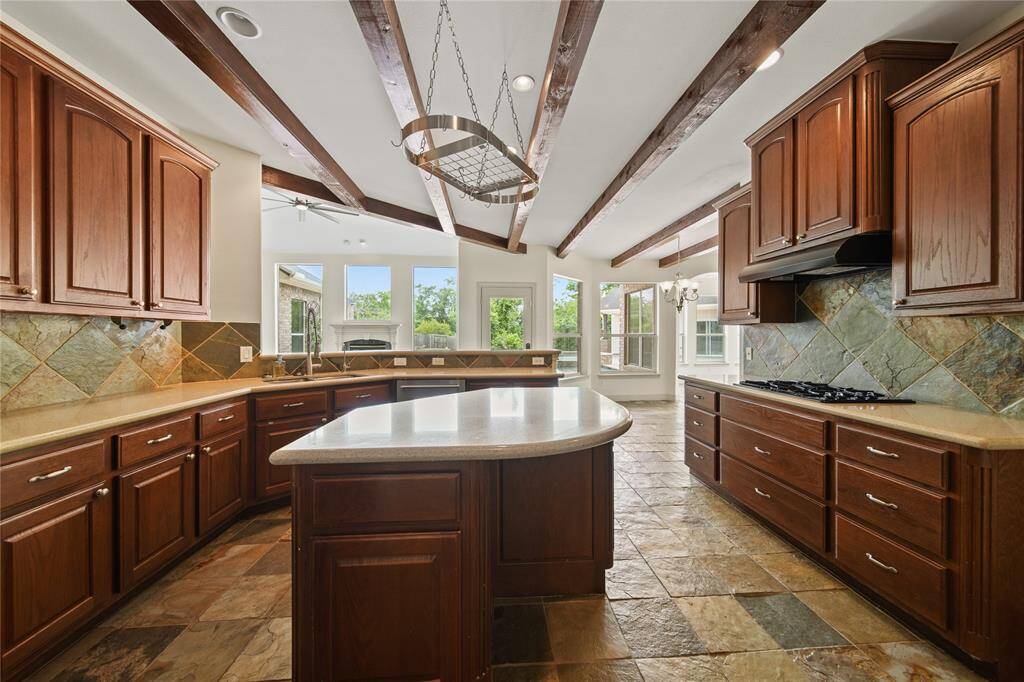 Large kitchen with island, stainless steel appliances and plenty of counter space.