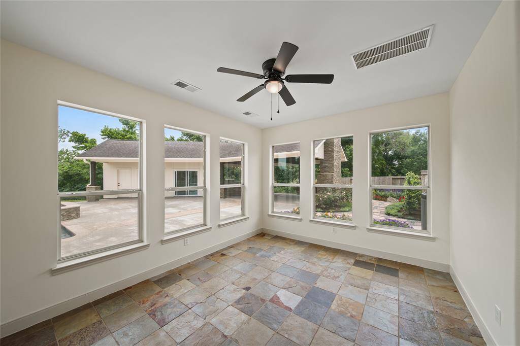 Sunroom over looking the gorgeous landscaping and backyard.