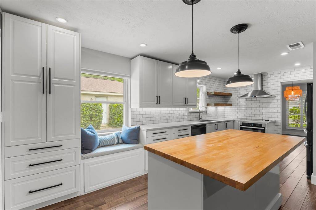 Check out this gourmet kitchen with butcher block island and ample cabinets!