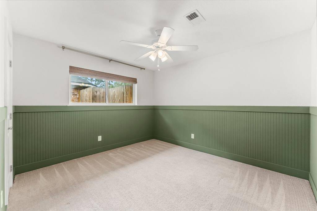 Secondary bedroom with accent walls.
