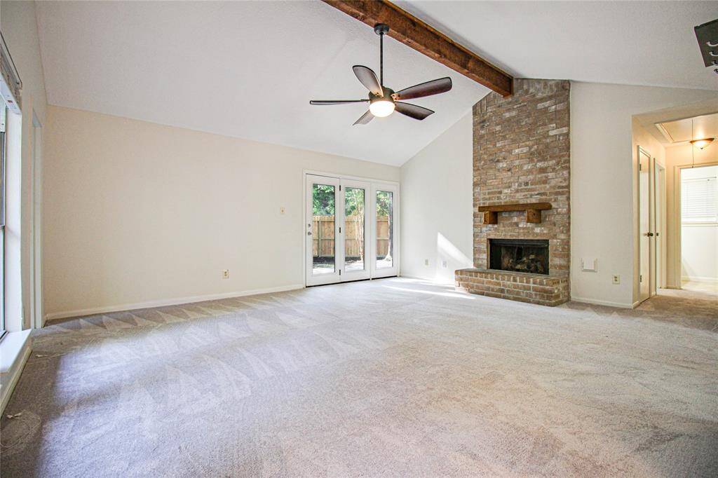 Living room has a fireplace and high ceiling.