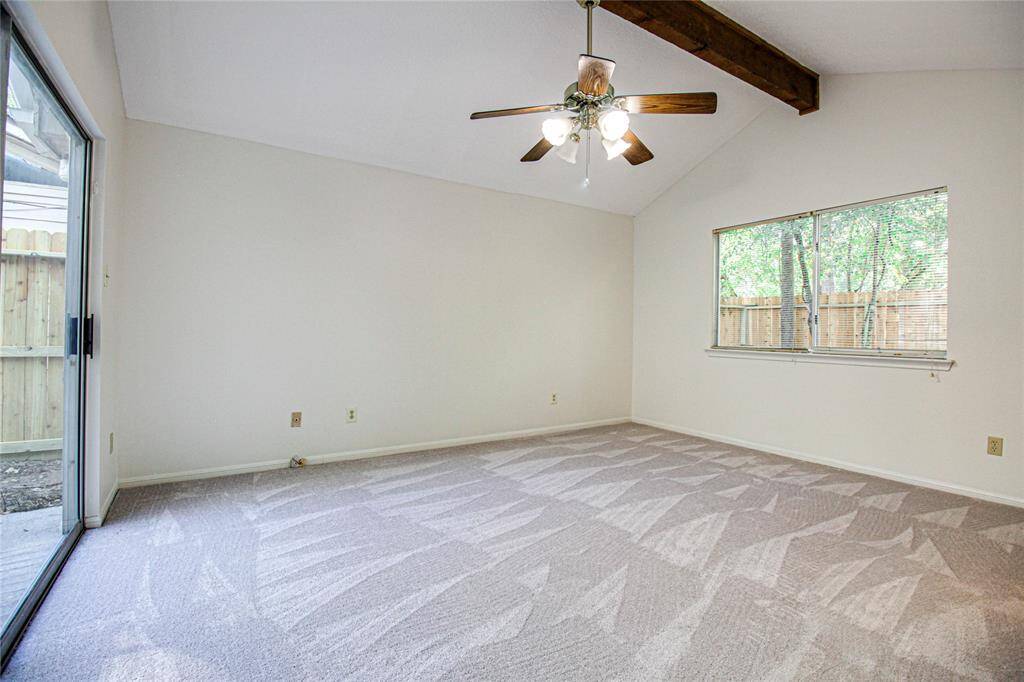 Primary bedroom has sliding glass doors to side patio.