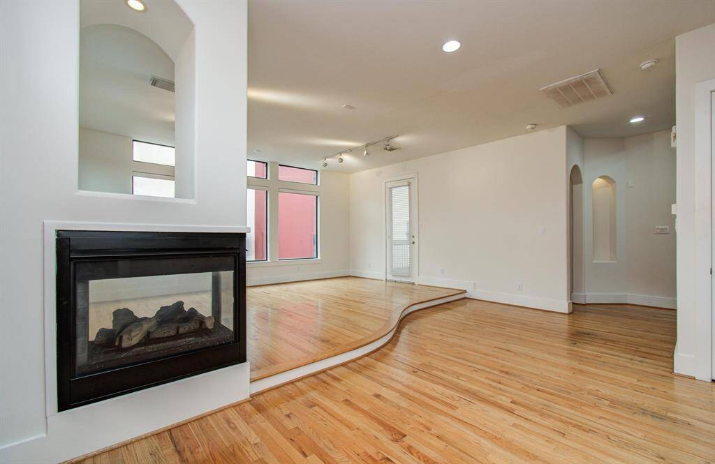 View from Dining Room next to the romantic fireplace.  Notice the elegant curve of the flooring.   And the art niches for displaying works of art.