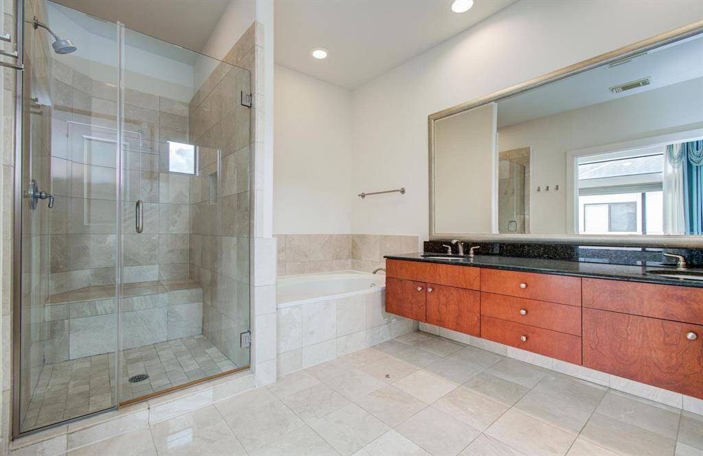 Master Bathroom features granite counters, a walk in shower and a soaking tub.