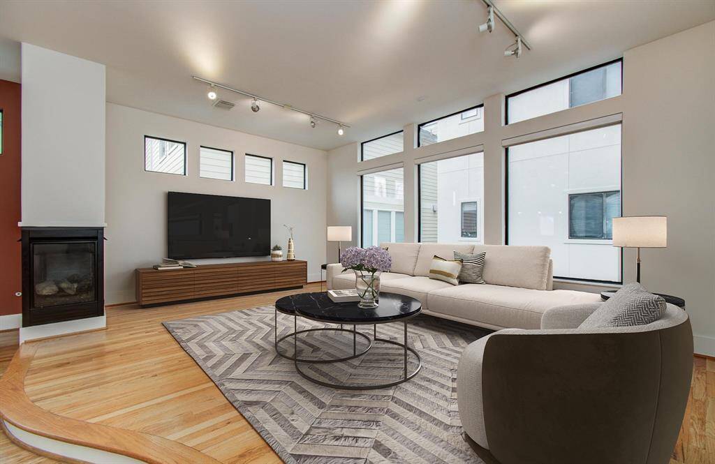 Living Room has high ceilings and big windows. Airy and bright with plenty of natural light. Virtually Staged.