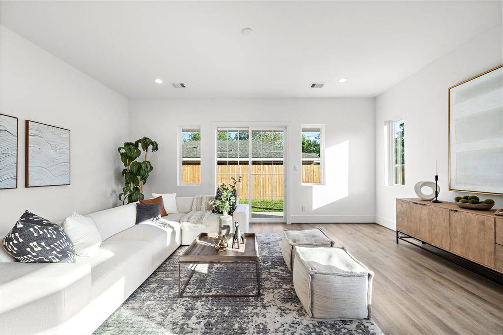 The living room offers seamless access to your spacious private backyard and a covered balcony, perfect for outdoor grilling.