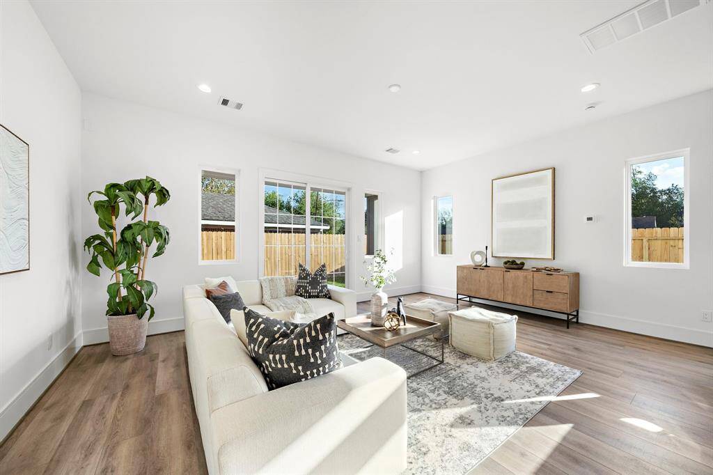 Spacious and inviting, the living room easily accommodates a large sofa with a chaise, making it the perfect space to host and entertain friends and family in style.