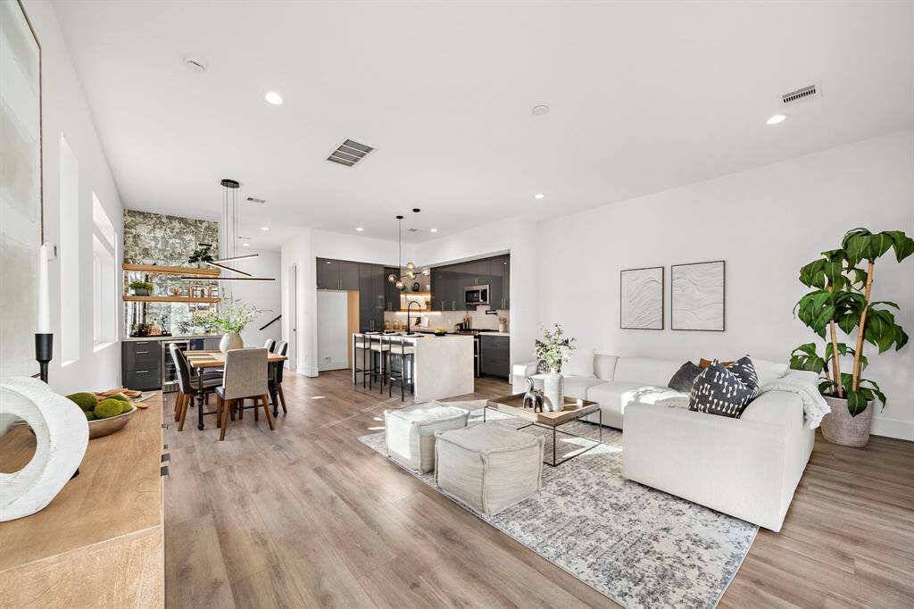 Bathed in natural sunlight, the living room showcases stunning paneled glass sliding doors that open to your beautifully turfed backyard, blending indoor and outdoor living effortlessly.