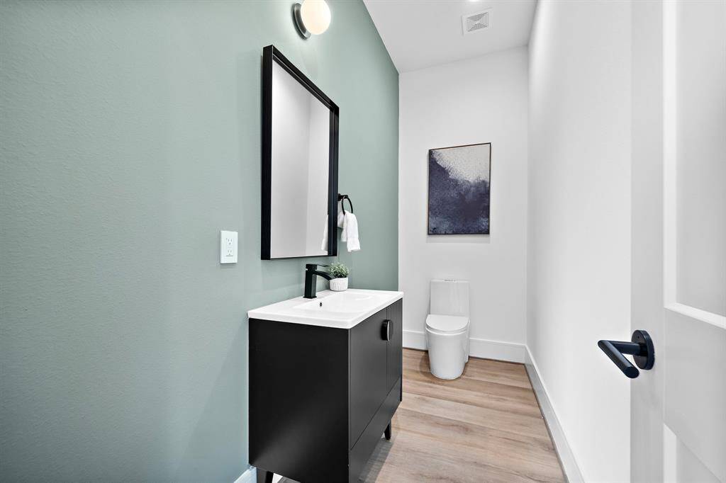 The powder room is thoughtfully tucked away just behind the kitchen, offering a private and convenient space for you and your guests to freshen up.