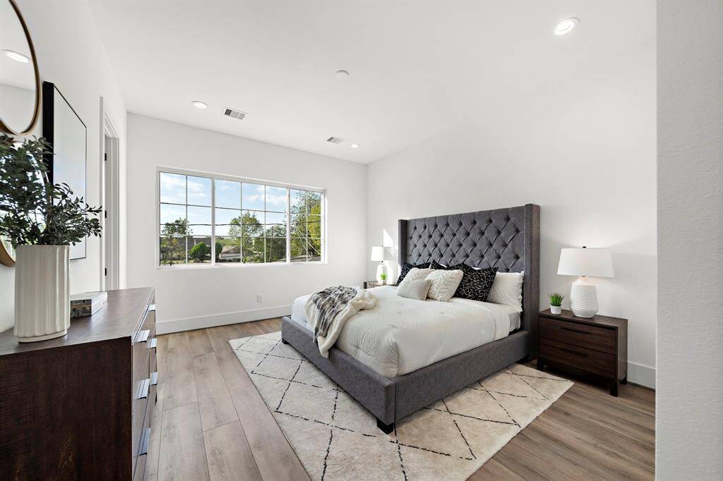 The primary bedroom is a true showstopper, featuring expansive windows that flood the space with natural sunlight. And just wait until you see the two spacious closets—fit for any king or queen!