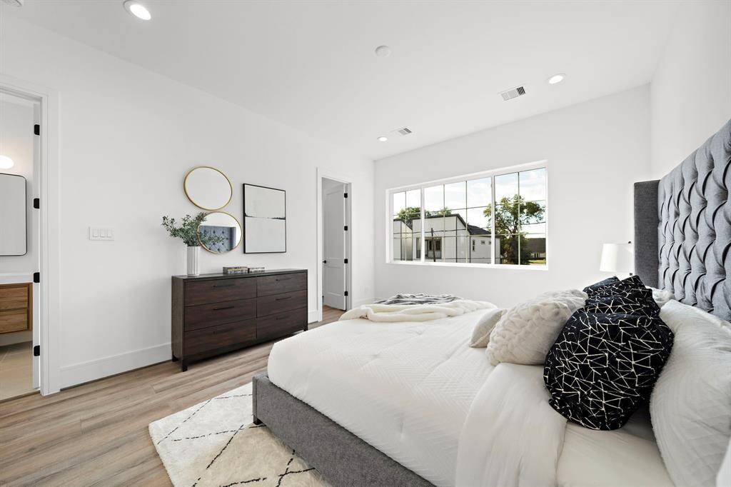 Complete with his-and-her closets, impressive 8-foot doors, and soaring 10-foot ceilings, this primary bedroom offers a welcoming and relaxing retreat after a long day.