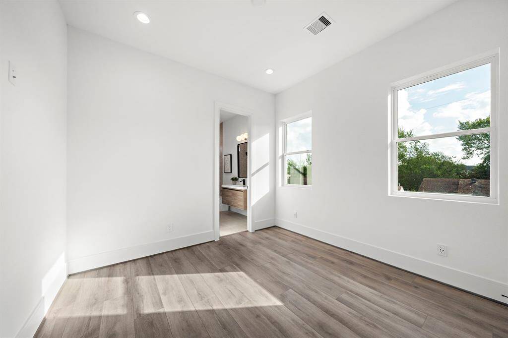 This is the first of two secondary guest bedrooms, complete with a ceiling fan—perfectly suited for a cozy home office.