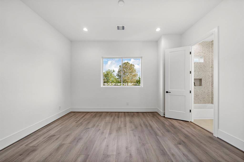 The second spacious guest bedroom measures an impressive 14' x 14', rivaling the size of primary bedrooms in many homes and offering versatility and comfort.