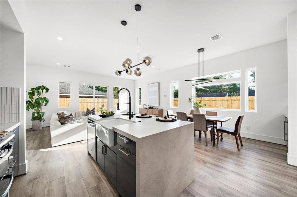 Experience convenience and style with sleek soft-close cabinets throughout, including a spacious pullout designed to neatly house your trash and recycling bins.