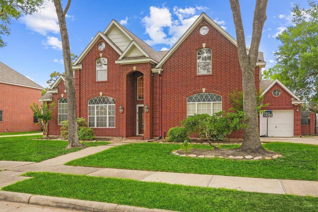Gorgeous traditional red brick home with 3 car garage.