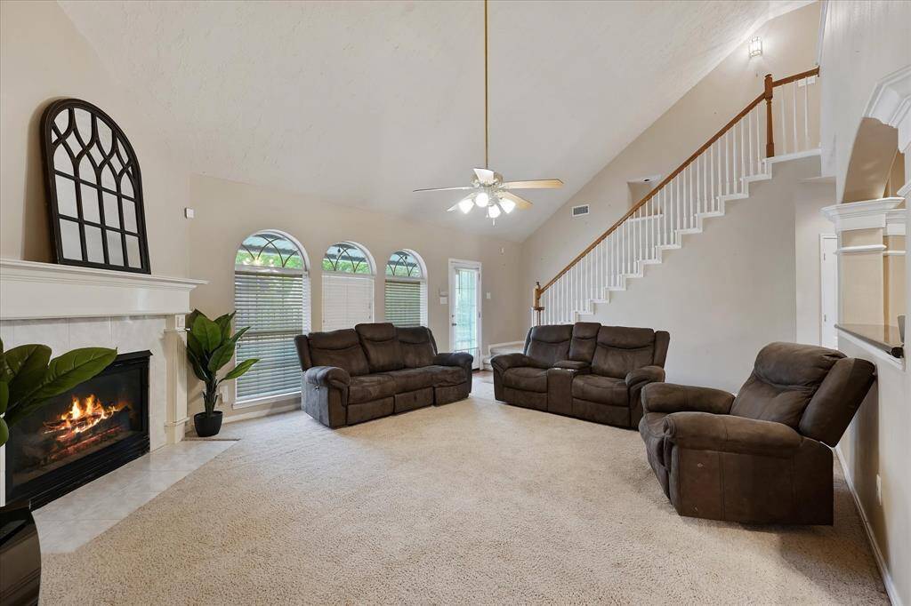 The living room has ample space with a vaulted ceiling.