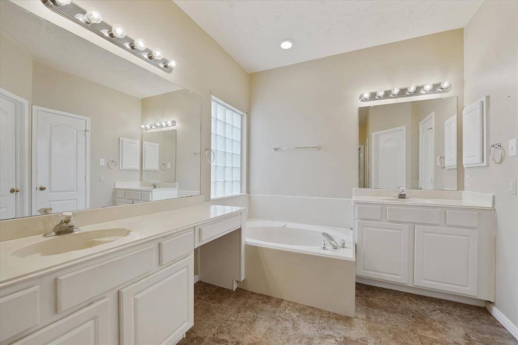 Primary bath has double vanity and seperate tub/shower.