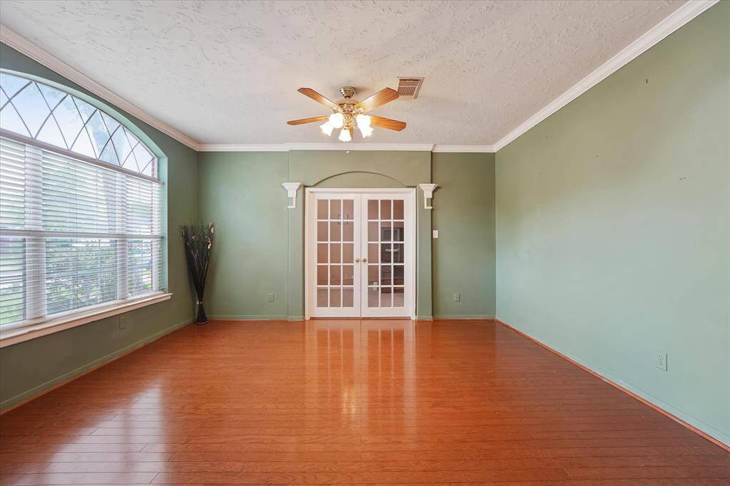 The french doors open up to a spacious office.