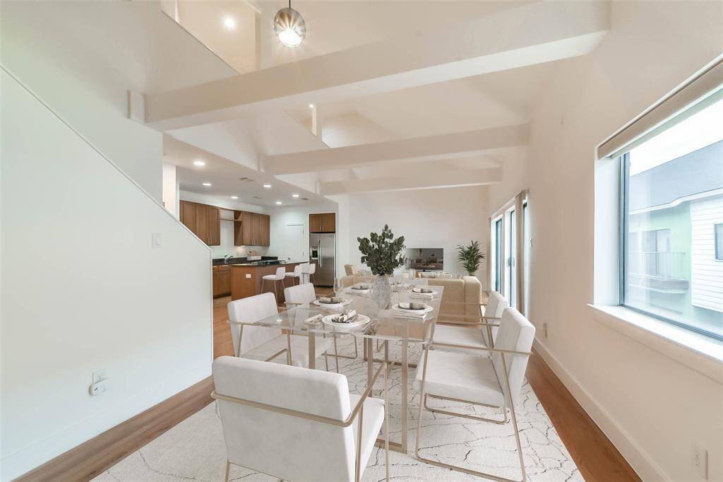 Soaring ceilings in the dining area with lots of natural light and open-concept flow great for entertaining. Virtually staged.